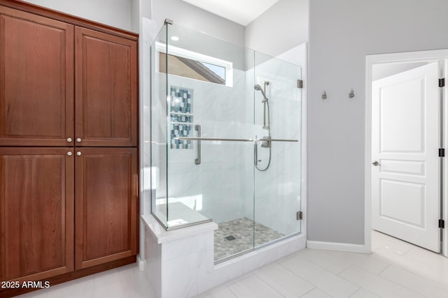 bathroom with tile patterned floors and a shower with door