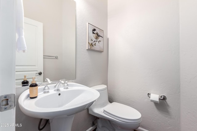 bathroom with toilet and sink