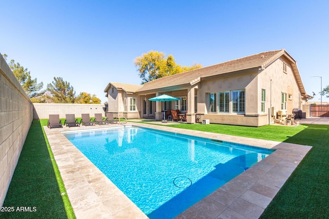 view of pool featuring a patio area and a lawn