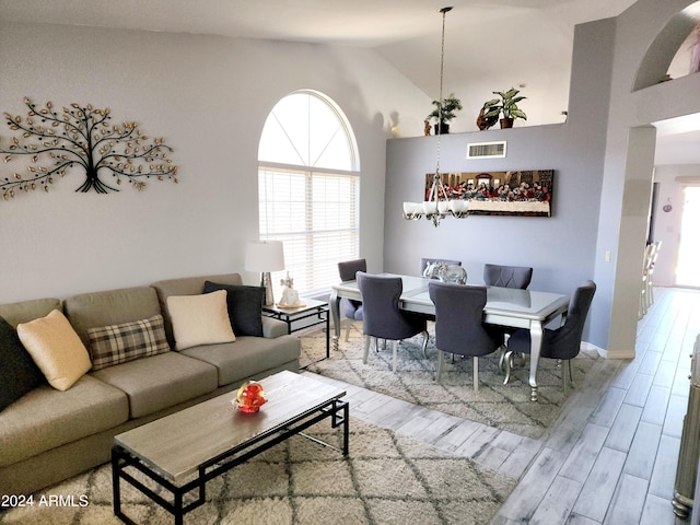 living room featuring high vaulted ceiling and wood-type flooring