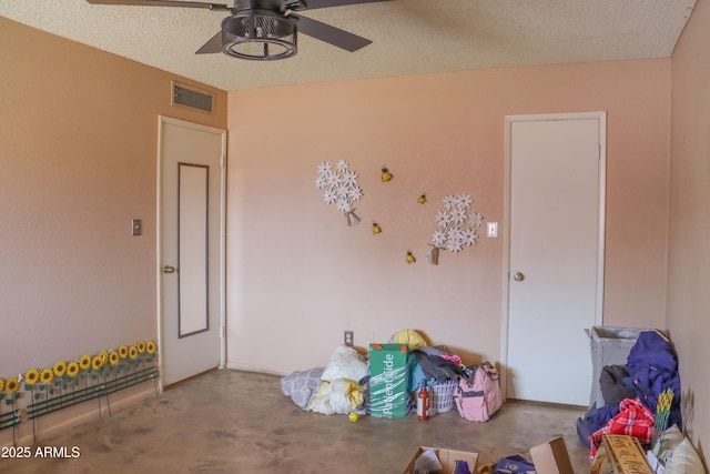 interior space featuring visible vents and ceiling fan