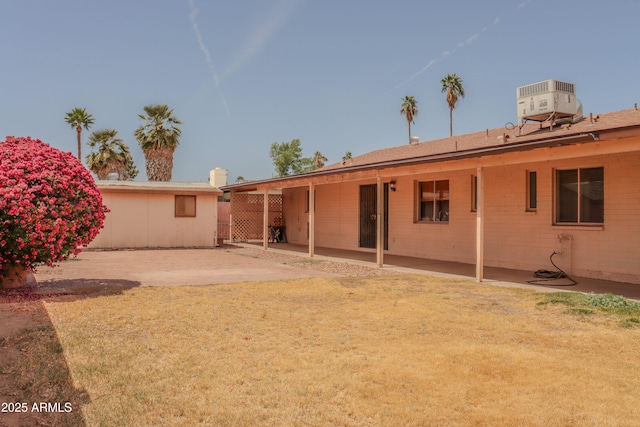 back of property with a patio and central AC unit