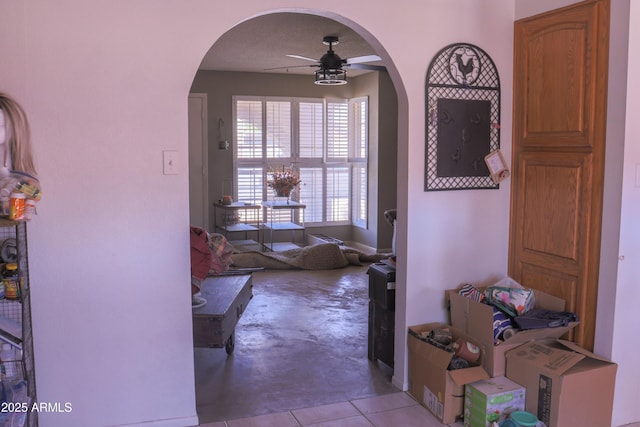 hallway featuring concrete flooring and arched walkways