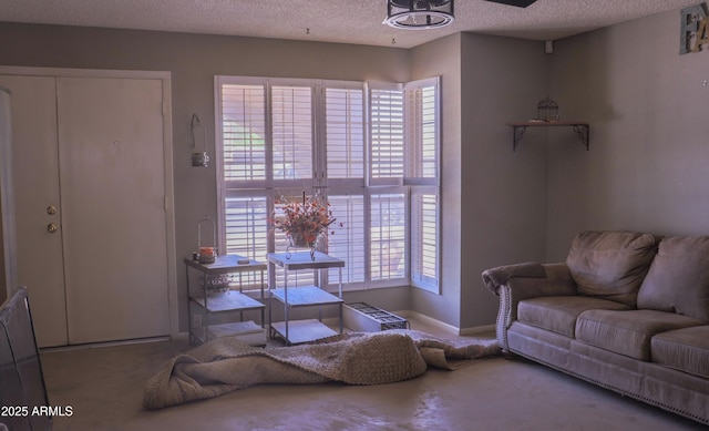 carpeted living area featuring a textured ceiling and baseboards