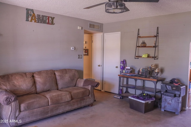 living room with a textured ceiling, visible vents, and a ceiling fan
