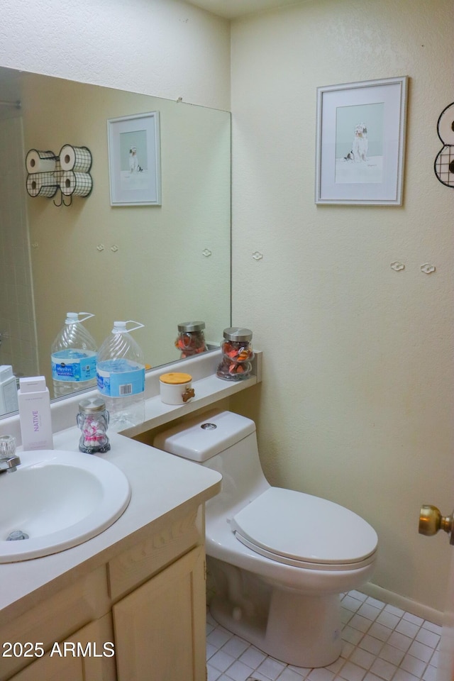bathroom with tile patterned floors, vanity, and toilet