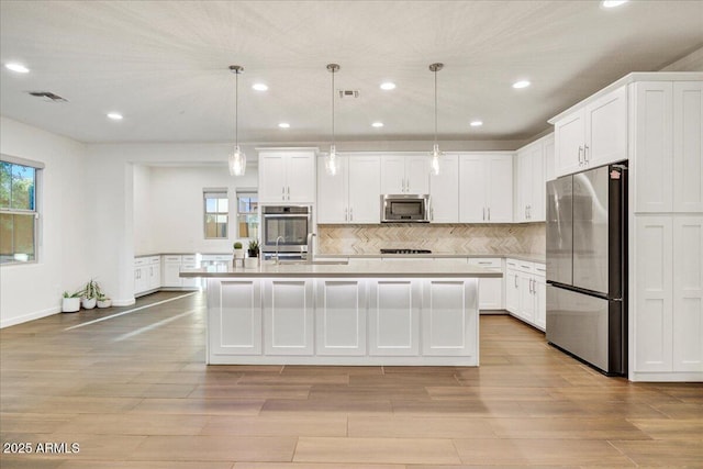 970 W Zion Way, Chandler, AZ 85248 - kitchen featuring stainless steel appliances, light countertops, recessed lighting, white cabinetry, and light wood-type flooring