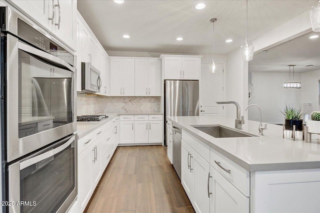 970 W Zion Way, Chandler, AZ 85248 - kitchen with a sink, stainless steel appliances, recessed lighting, a center island with sink, and light countertops
