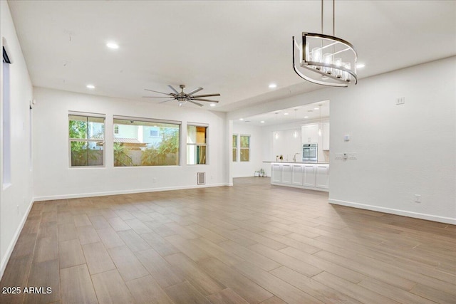 970 W Zion Way, Chandler, AZ 85248 - unfurnished living room featuring a ceiling fan, light wood-style flooring, recessed lighting, and baseboards