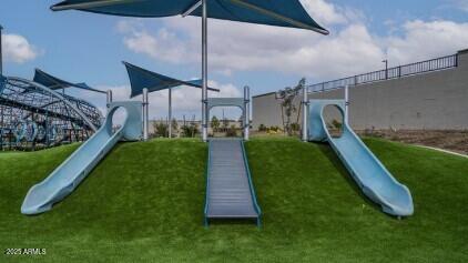 view of playground with a lawn