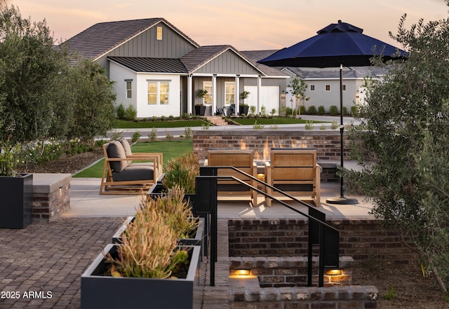 11300 N Casa Dega Dr Unit 1019, Surprise, AZ 85388 - back of house at dusk with board and batten siding and a patio
