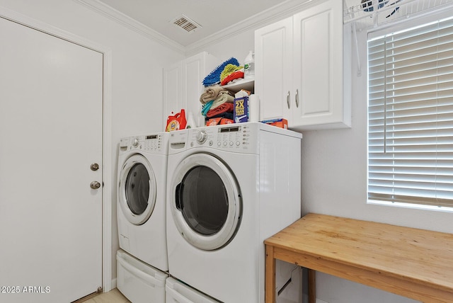 laundry area with crown molding, cabinet space, independent washer and dryer, and visible vents