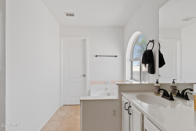 bathroom featuring visible vents, a garden tub, tile patterned flooring, and vanity