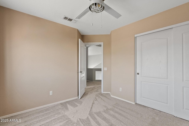 unfurnished bedroom featuring light colored carpet, a ceiling fan, baseboards, and visible vents