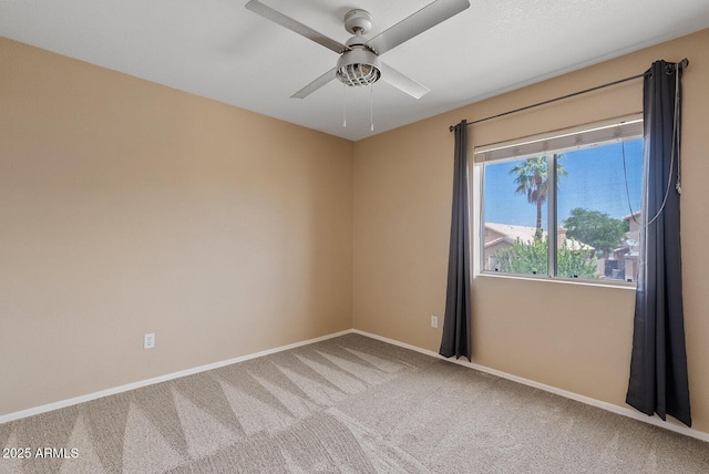 unfurnished room with carpet floors, a ceiling fan, and baseboards