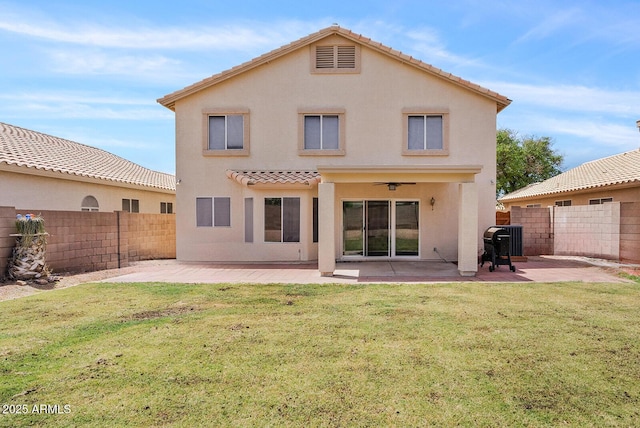back of house featuring ceiling fan, a fenced backyard, stucco siding, a patio area, and a lawn
