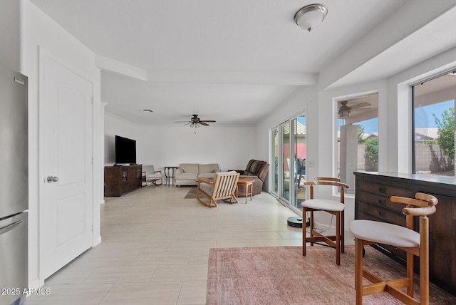living room with a ceiling fan and french doors