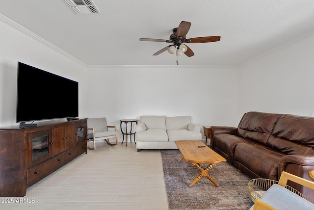 living area with crown molding, a ceiling fan, and visible vents