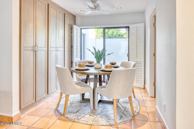 dining area with ceiling fan and light tile patterned floors