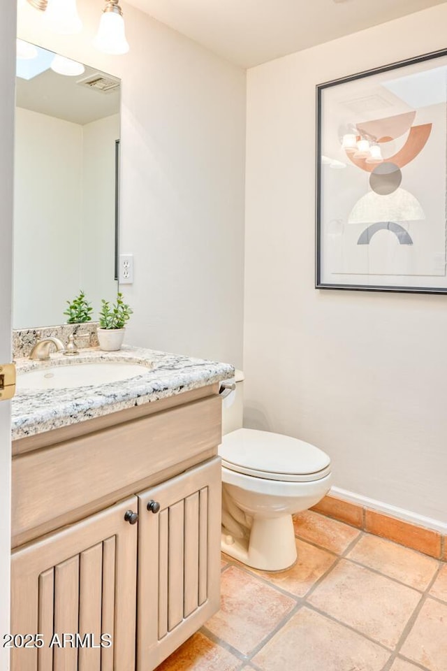 bathroom featuring toilet and vanity