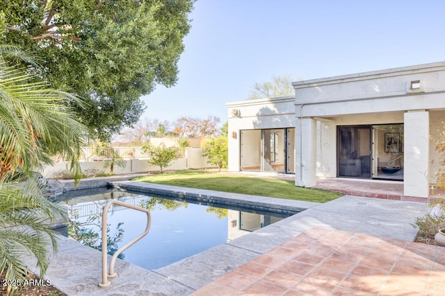 view of swimming pool with a lawn and a patio