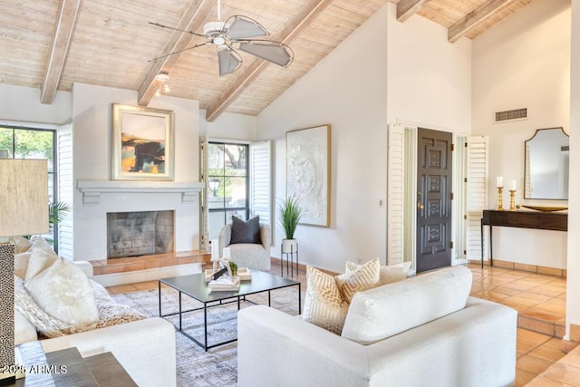 living room with beamed ceiling, light tile patterned floors, and wood ceiling