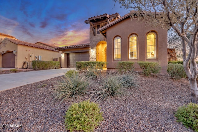 mediterranean / spanish-style home featuring a garage