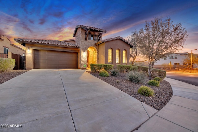 mediterranean / spanish-style house with a garage