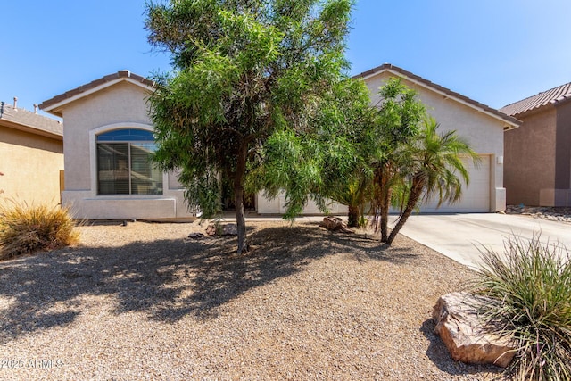 3553 W Dancer Ln, San Tan Valley, AZ 85144 - obstructed view of property featuring driveway, an attached garage, and stucco siding