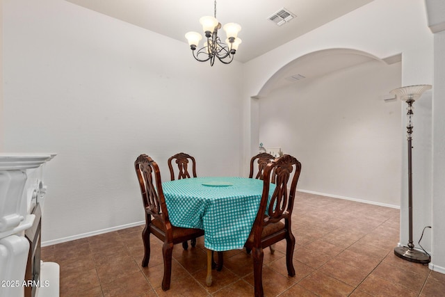 3553 W Dancer Ln, San Tan Valley, AZ 85144 - dining space with arched walkways, a chandelier, and tile patterned flooring