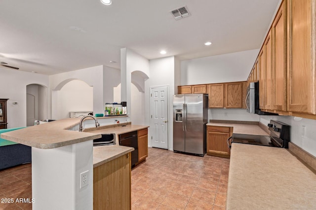 3553 W Dancer Ln, San Tan Valley, AZ 85144 - kitchen featuring black appliances, arched walkways, brown cabinetry, light countertops, and light tile patterned floors
