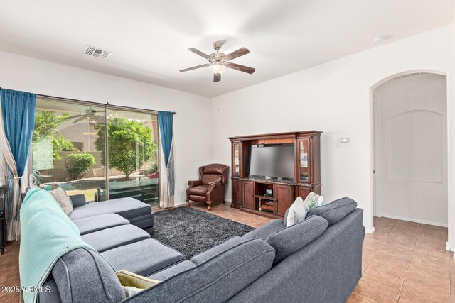 3553 W Dancer Ln, San Tan Valley, AZ 85144 - living room featuring ceiling fan, light tile patterned floors, and arched walkways