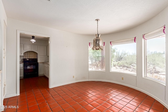1305 Coyote Pass, Carefree, AZ 85377 - unfurnished dining area featuring dark tile patterned floors, baseboards, and a notable chandelier