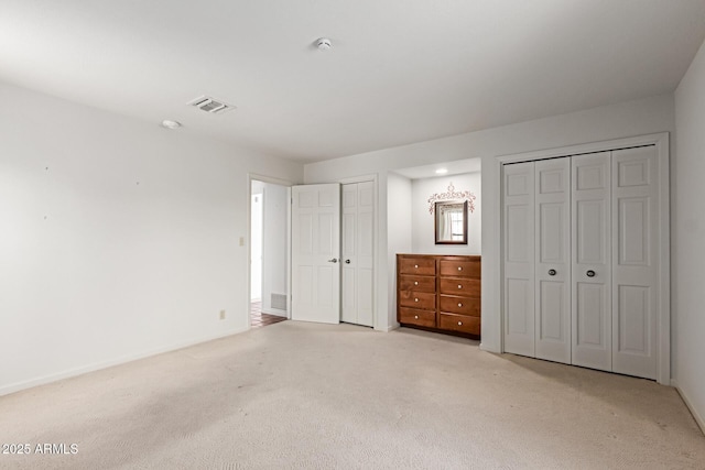 1305 Coyote Pass, Carefree, AZ 85377 - unfurnished bedroom with two closets, light colored carpet, baseboards, and visible vents