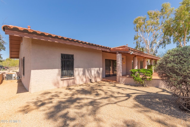1305 Coyote Pass, Carefree, AZ 85377 - rear view of property featuring central air condition unit, stucco siding, and a tiled roof