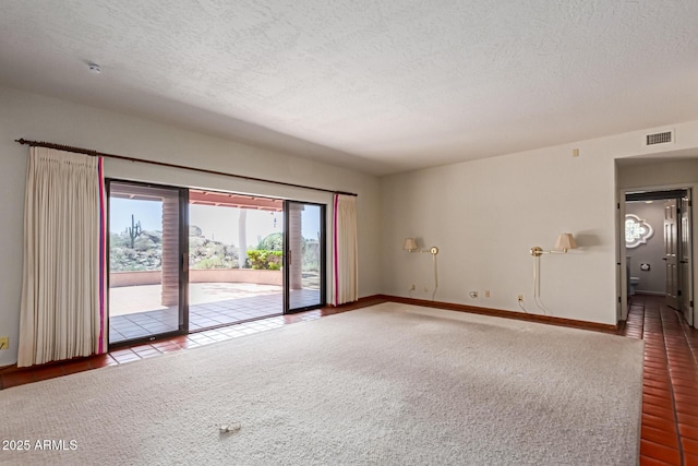 1305 Coyote Pass, Carefree, AZ 85377 - spare room with carpet, visible vents, a textured ceiling, and baseboards