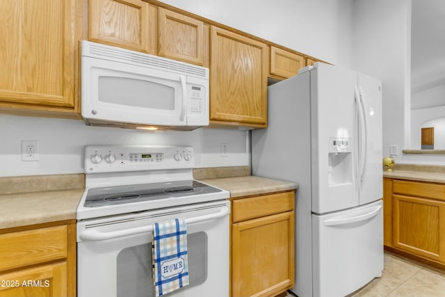 kitchen featuring light tile patterned floors and white appliances