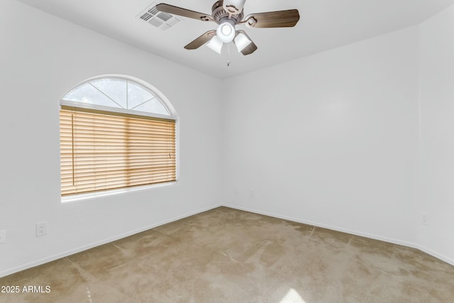 unfurnished room featuring light colored carpet and ceiling fan