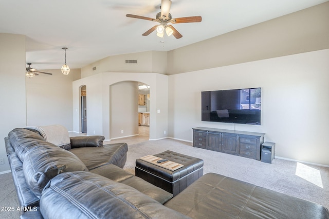 5944 W Greenbriar Dr, Glendale, AZ 85308 - carpeted living area featuring vaulted ceiling, visible vents, arched walkways, baseboards, and ceiling fan