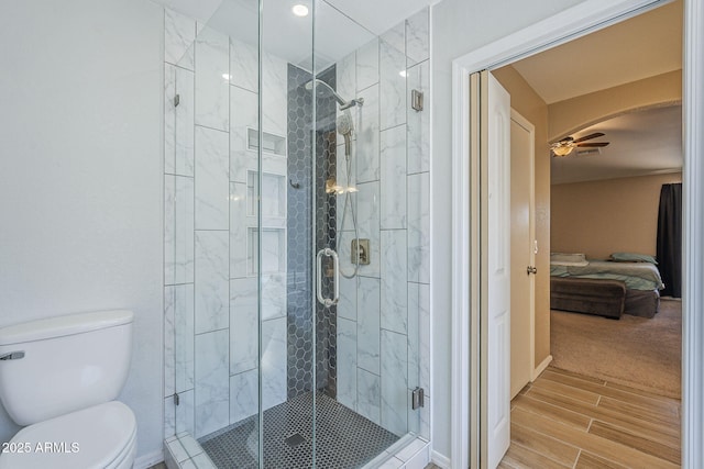 5944 W Greenbriar Dr, Glendale, AZ 85308 - ensuite bathroom featuring toilet, a ceiling fan, wood tiled floor, and a stall shower