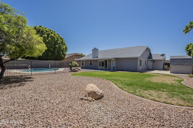 5944 W Greenbriar Dr, Glendale, AZ 85308 - rear view of house featuring a patio area, a chimney, fence, an outbuilding, and a fenced in pool