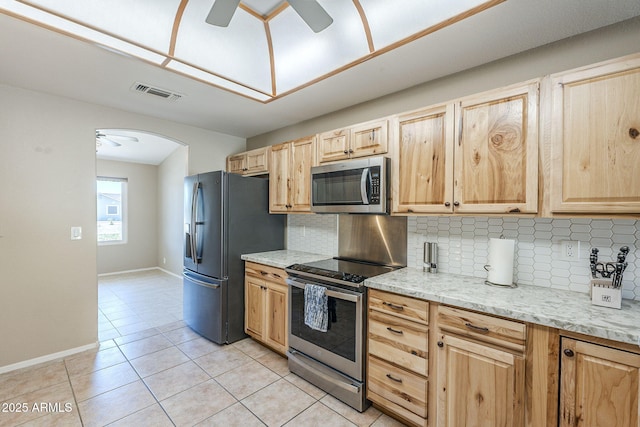 5944 W Greenbriar Dr, Glendale, AZ 85308 - kitchen with light brown cabinets, a ceiling fan, stainless steel appliances, and visible vents