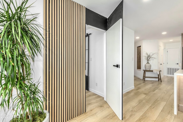 corridor with light hardwood / wood-style floors