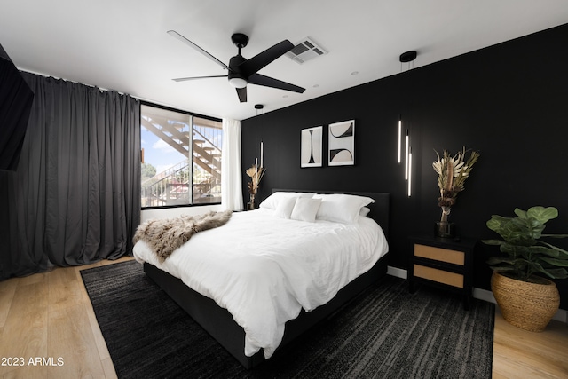 bedroom featuring ceiling fan and hardwood / wood-style floors