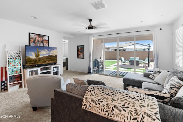 carpeted living room with ceiling fan