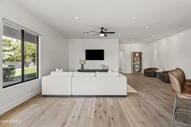 living room featuring recessed lighting, light wood-style flooring, visible vents, and baseboards