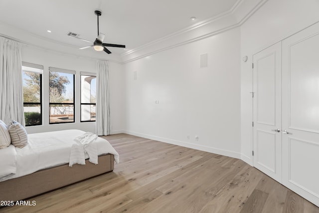 bedroom with visible vents, light wood-style flooring, recessed lighting, crown molding, and baseboards