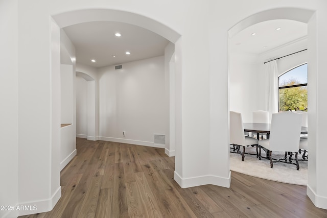 hall featuring recessed lighting, wood finished floors, visible vents, and baseboards