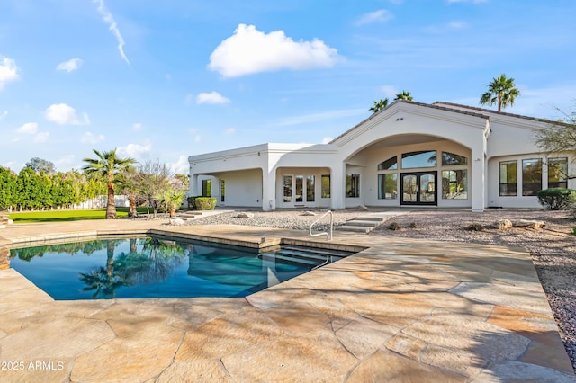 pool with a patio area and french doors