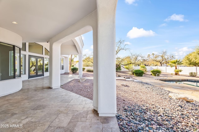 view of patio / terrace featuring a fenced in pool and fence